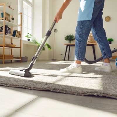 Cropped,Photo,Of,Woman,Cleaning,With,Vacuum,Cleaner,Carpet,In