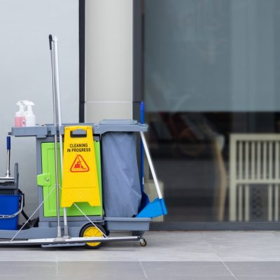 A,Cleaning,Cart,With,A,Yellow,Sign,On,It.,The